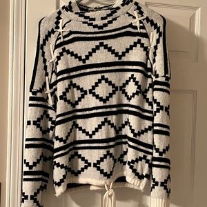 Sweater. Black and White with cross stitch at arms drawstring at waist.